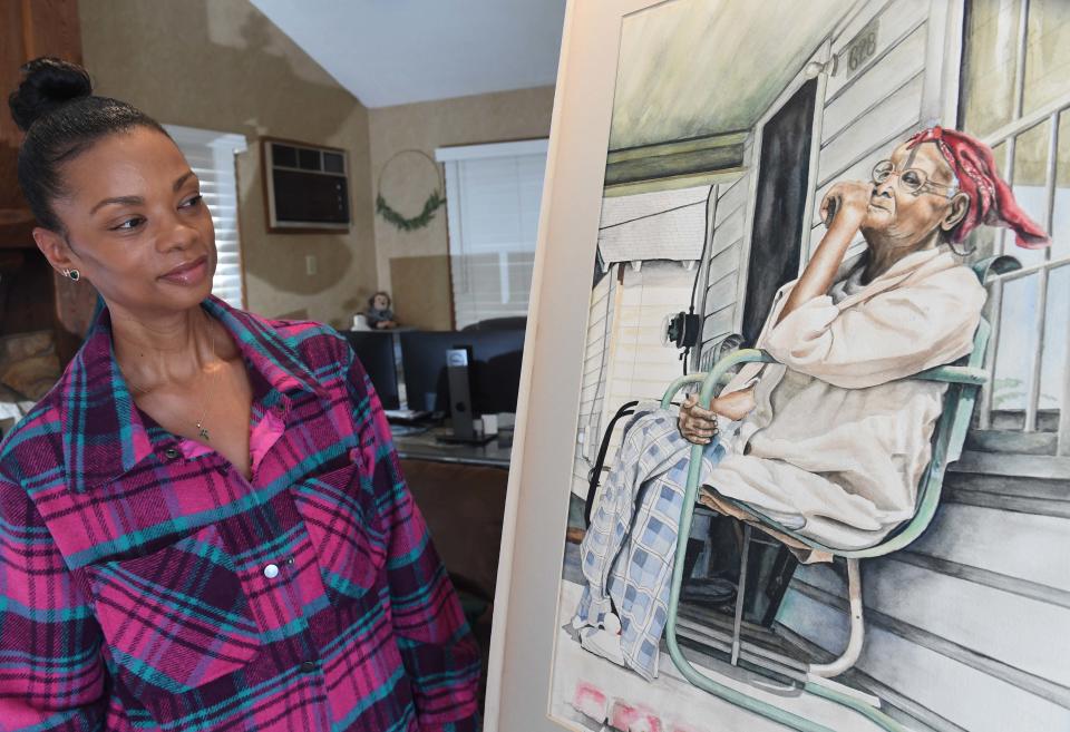 Heather Mitchell looks at a painting her father did of his grandmother, Janie Dantzler, which she said was his most prized possession.