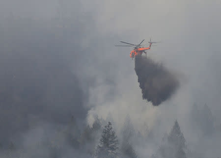 Firefighting helicopters work to contain a wildfire near Oakville, California, U.S., October 16, 2017. REUTERS/Jim Urquhart