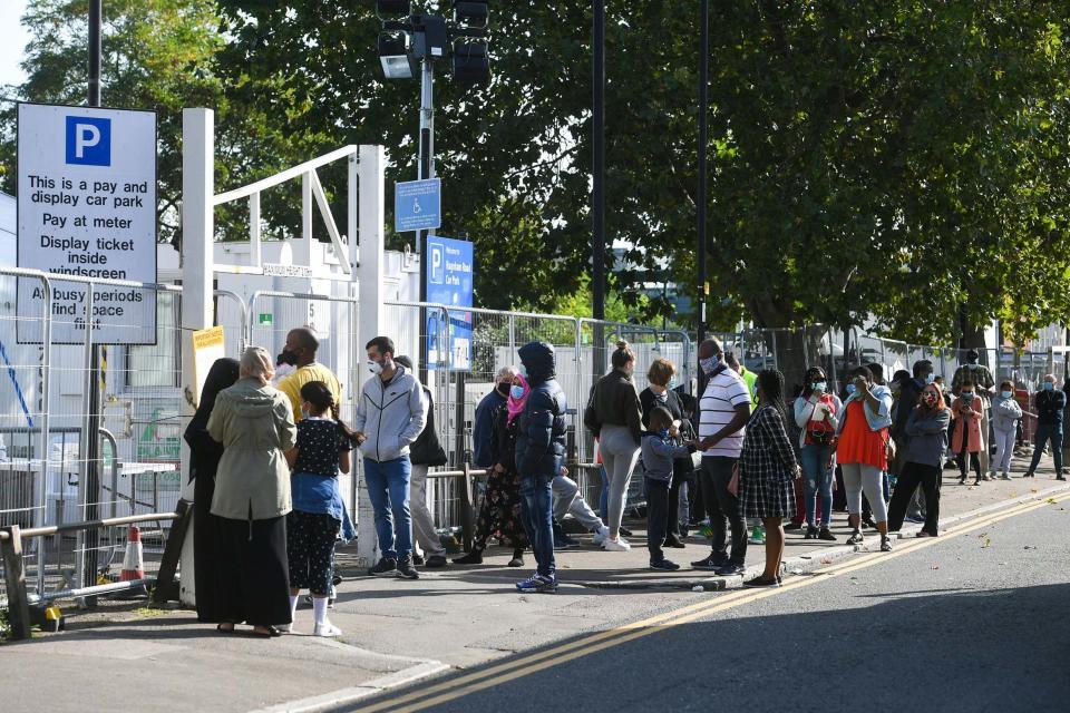 People queue up outside a coronavirus testing centre offering walk-in appointments in north London: PA