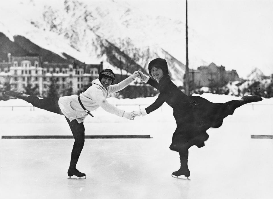 French figure skater Andree Joly (later known as Andree Brunet, 1901-1993) and American figure skater Beatrix Loughran (1900-1975) hold hands as they maintain a pose during a practice session at the Stade Olympique de Chamonix during the 1924 Winter Olympics in Chamonix, France, 16th January 1924.
