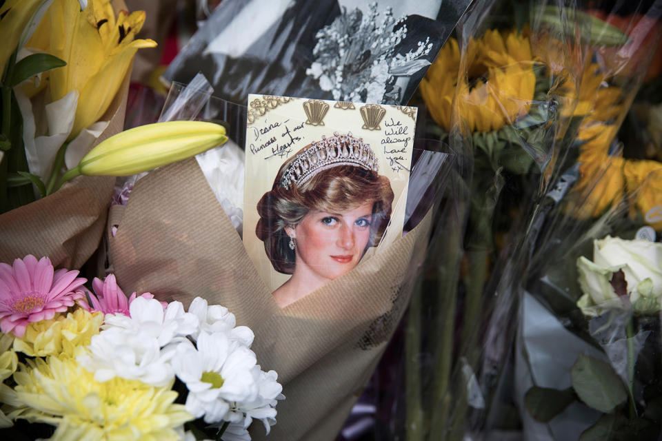 <p>Well-wishers and Royal ‘enthusiasts’ gather outside the gates of Kensington Palace where tributes continue to be left, on the 20th anniversary of the death of Princess Diana on Aug. 31, 2017 in London, England. (Photo: Dan Kitwood/Getty Images) </p>