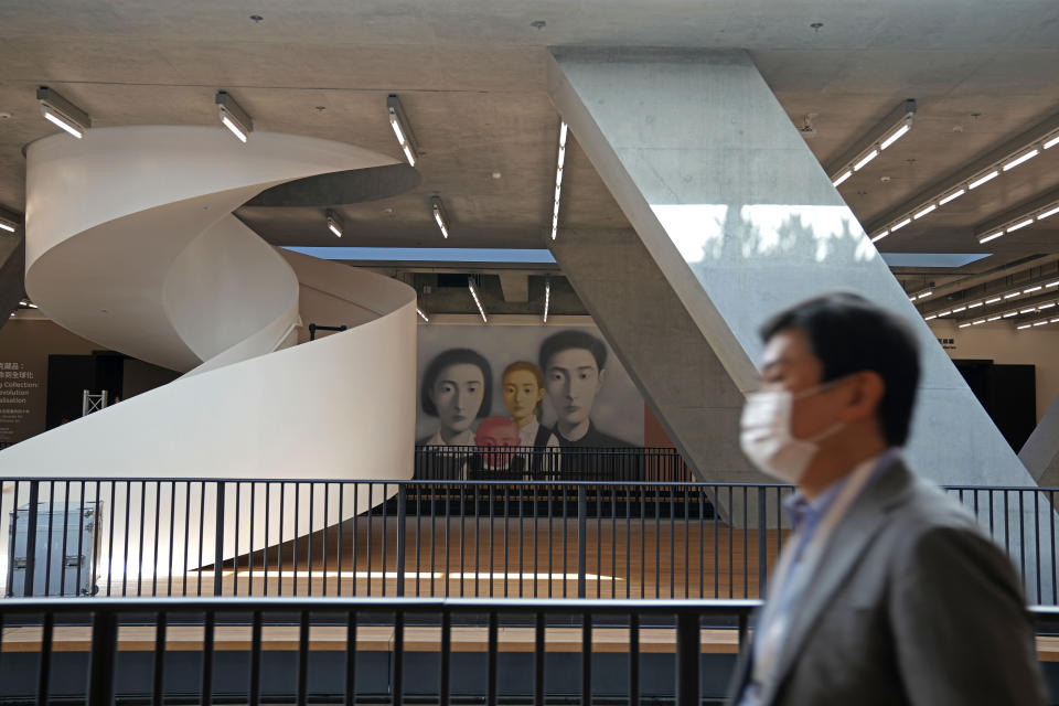 A man walks inside the "M+" visual culture museum during a media preview in the West Kowloon Cultural District of Hong Kong, Thursday, Nov. 11, 2021. Hong Kong's swanky new M+ museum _ Asia's largest gallery with a billion-dollar collection _ is set to open on Friday amid controversy over politics and censorship. (AP Photo/Kin Cheung)