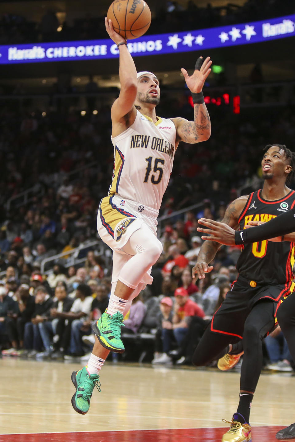 New Orleans Pelicans guard Jose Alvarado (15) shoots over Atlanta Hawks guard Delon Wright (0) in the first half of an NBA basketball game Sunday, March 20, 2022, in Atlanta, Ga. (AP Photo/Brett Davis)