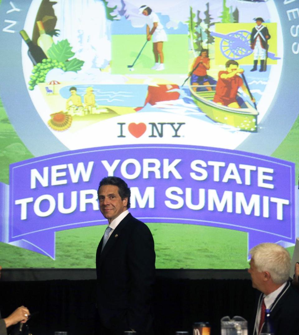 New York Gov. Andrew Cuomo arrives for the New York State Tourism Summit on Wednesday, May 8, 2013, in Albany, N.Y. The governor is trying to map out a better way to showcase New York state's seasonal attractions and boost businesses. The focus will range from summer attractions such as Niagara Falls, the Erie Canal and Adirondacks to the rebuilding of boardwalks and beaches on Long Island hit hard by Superstorm Sandy last fall. (AP Photo/Mike Groll)