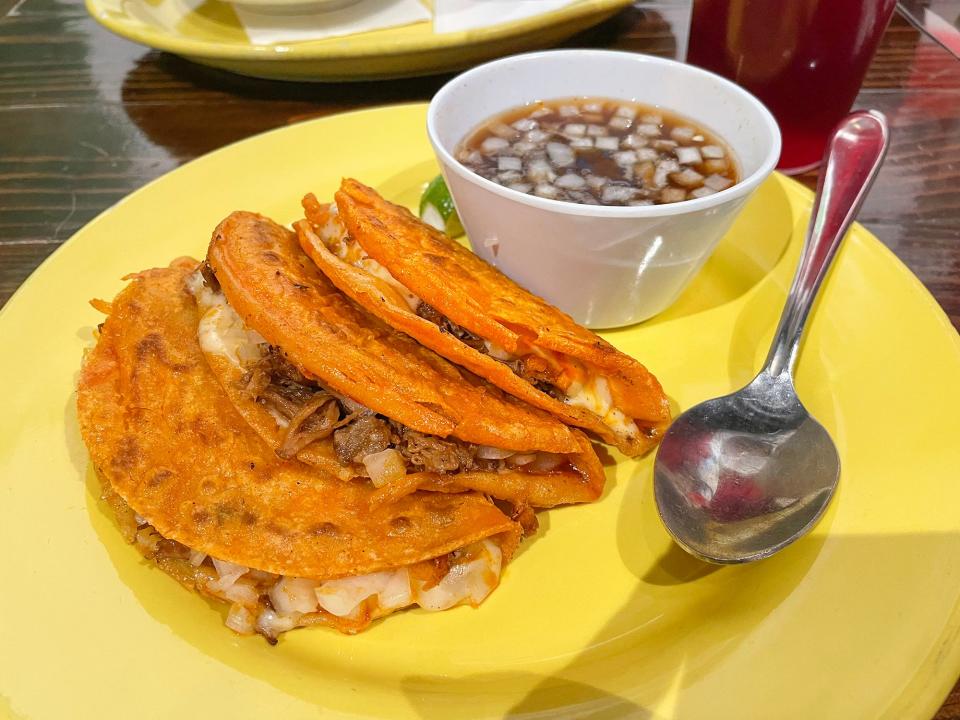 Quesabirria tacos with consommé at Agua Linda restaurant in Athens, Ga. on Tuesday, Dec. 19, 2023. The dish is a special item that is not part of Agua Linda's daily menu.