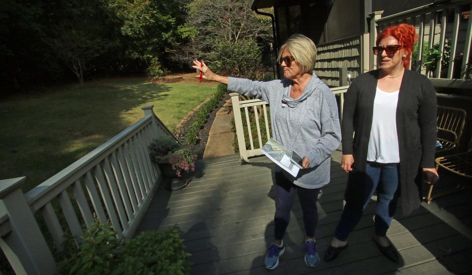 Lisa Dale and Kate Hamad talk about a possible future on the back deck of Kate Hamad’s home on Candlewick Way near where apartments may be built.