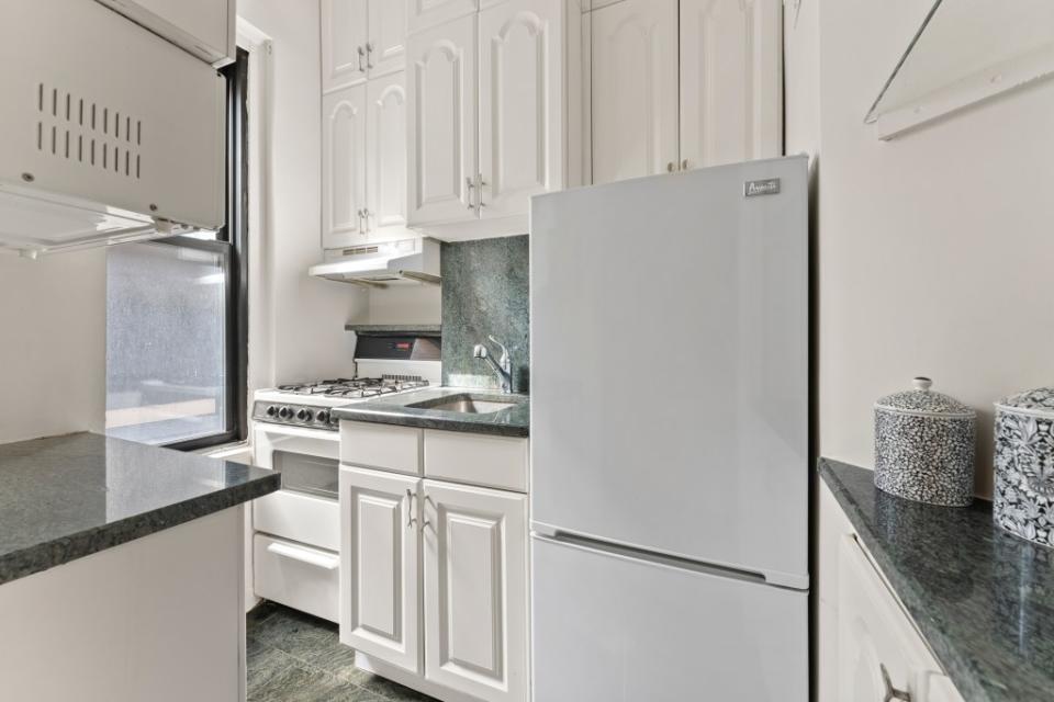 The first-floor apartment boasts high ceilings and a remodeled compact kitchen. Michael Muchnij