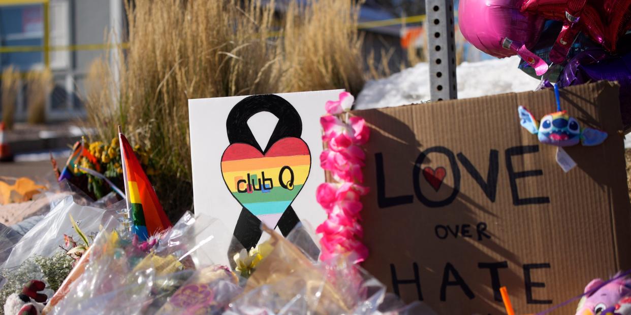 Flowers and signs for a memorial for Club Q victims.