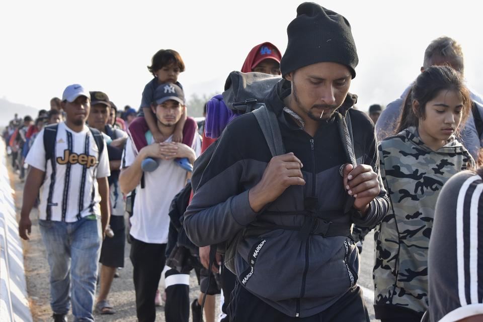 Migrants walk along the highway through Arriaga, Chiapas state in southern Mexico, Monday, Jan. 8, 2024, during their journey north toward the U.S. border. (AP Photo/Edgar H. Clemente)