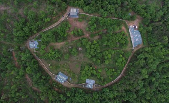 An aerial view of the Project Chimps sanctuary in Morganton, Georgia, showing four "villas," one "group building" at the far right and a six-acre communal space in the center.