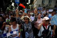 People shout slogans during a protest outside Radio Television Hong Kong Broadcasting House headquarters in Hong Kong