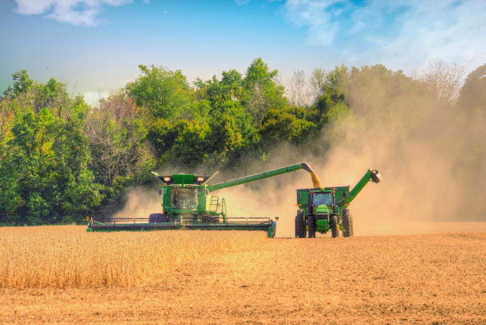 A combine harvester working in an open field.