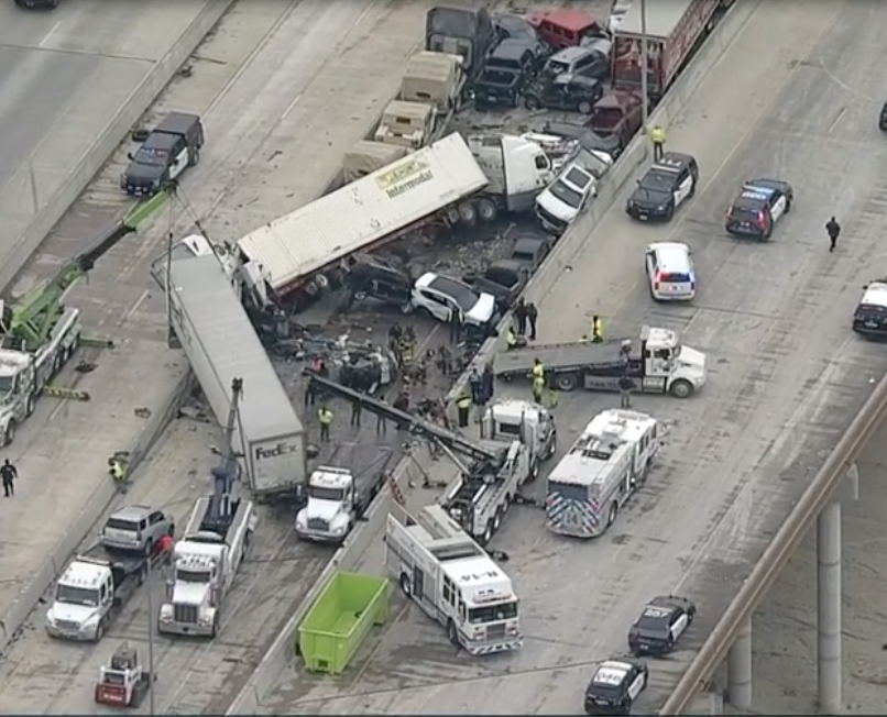 Helicopter footage shows overturned trucks and cars piled on top of one another.