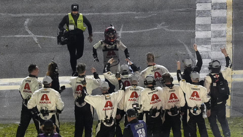 William Byron, wearing helmet, celebrates with his crew after winning the NASCAR Daytona 500 auto race Monday, Feb. 19, 2024, at Daytona International Speedway in Daytona Beach, Fla. (AP Photo/Chris O'Meara)