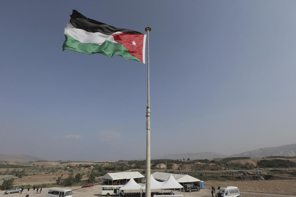 FILE - In this Nov. 13, 2019, file photo, the Jordanian national flag flies in the area of ​​Baqoura. Jordan’s health minister stepped down Saturday after at least six patients in a hospital COVID-19 patient ward died due to a shortage of oxygen supplies, state media reported. (AP Photo/Raad Adayleh, File)