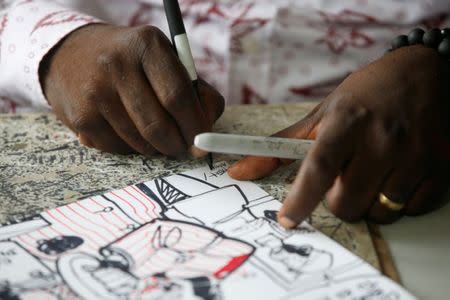 Thembo Kashauri, Democratic Republic of Congo's best-known political cartoonist signs his name on a drawing in an office in Kinshasa, Democratic Republic of Congo, December 26, 2018. Picture taken December 26, 2018. REUTERS/Baz Ratner