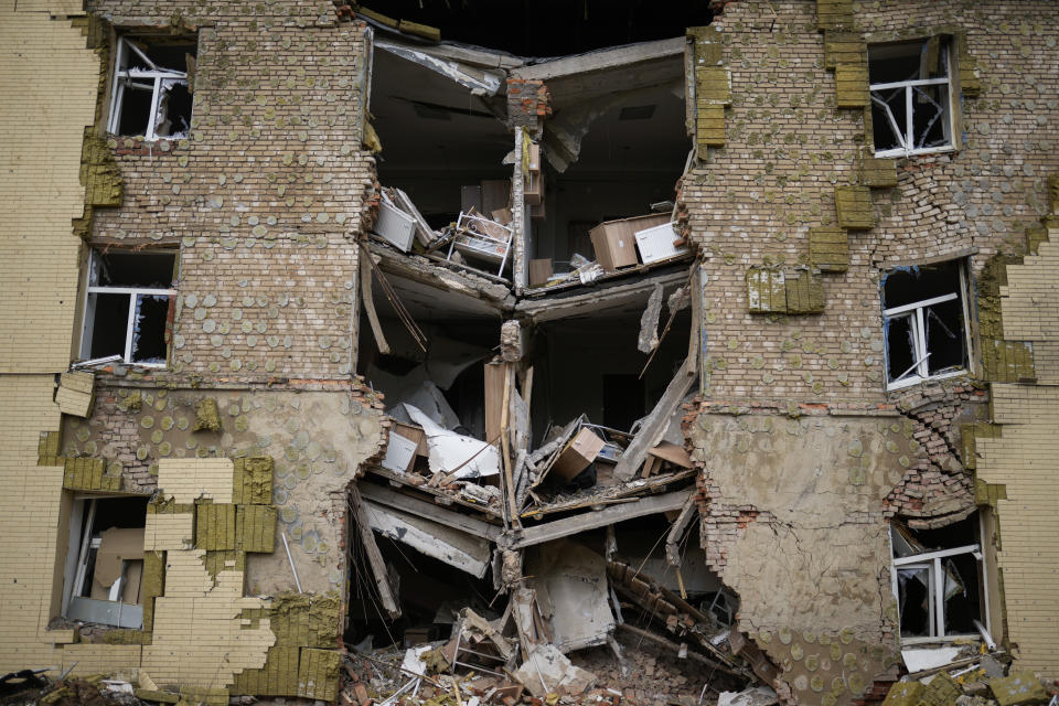 Debris hangs from a residential building heavily damaged in a Russian bombing in Bakhmut, eastern Ukraine, eastern Ukraine, Saturday, May 28, 2022. Fighting has raged around Lysychansk and neighbouring Sievierodonetsk, the last major cities under Ukrainian control in Luhansk region. (AP Photo/Francisco Seco)