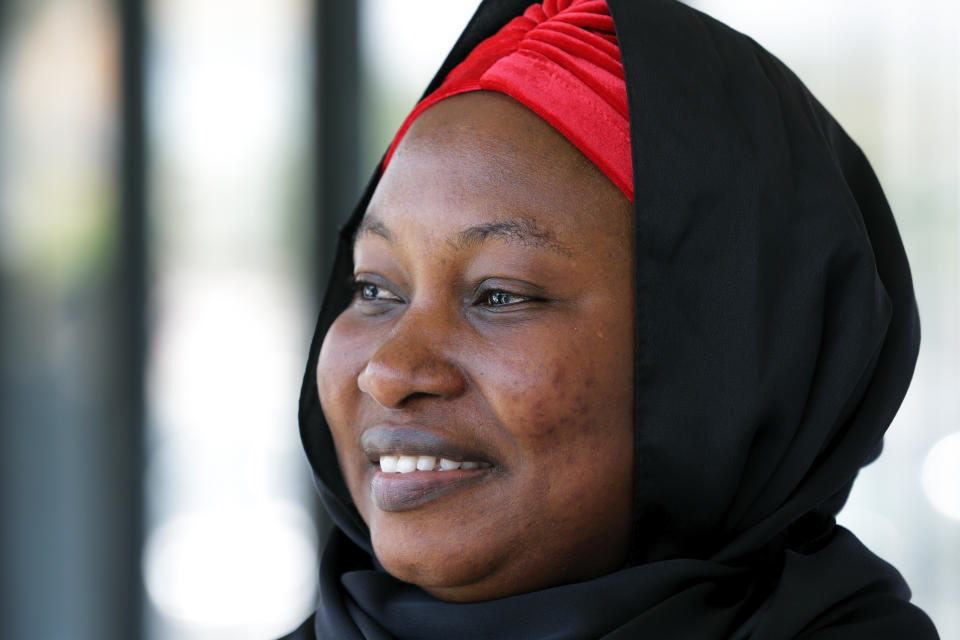 Maimouna Cissoko smiles after filling out voter registration forms, after months of trying with state agencies, at a table set up by Emgage Texas, outside the Masjid Al-Qur'an mosque on Wednesday, July 28, 2023, in Houston. (AP Photo/Michael Wyke)