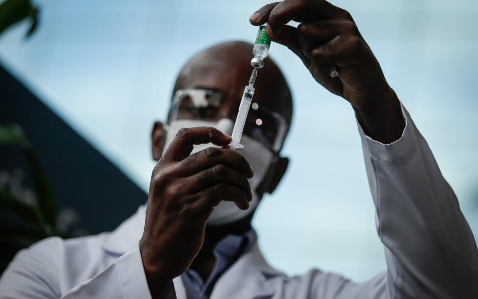 A healthcare worker prepares a dose of the Astrazeneca/Oxford vaccine in Rio de Janeiro - Getty