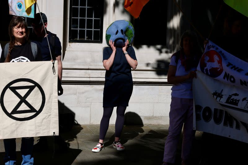 Climate activists await a ruling on whether planning permission granted for oil wells in southern England was lawful, outside the Supreme Court in London