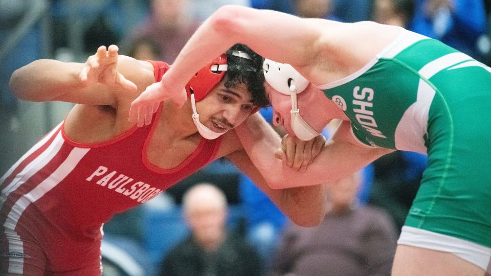 Paulsboro's Keros Cooper, left, battles West Deptford's Owen Entrekin for a takedown during the 132 lb. bout of the championship round of the District 28 wrestling tournament held at the Rowan College of South Jersey in Deptford on Saturday, February 17, 2024. Cooper defeated Entrekin, 15-7.