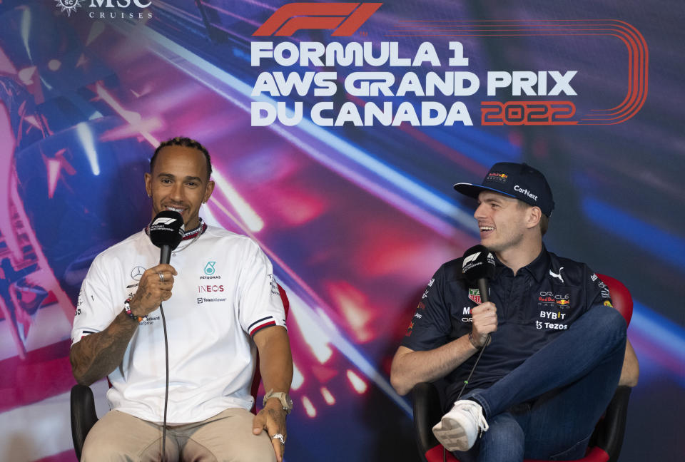 Mercedes Team driver Lewis Hamilton, left, of Great Britain, and Red Bull Racing driver Max Verstappen, of the Netherlands, share a laugh during a news conference at the Canadian Grand Prix auto race, Friday, June 17, 2022, in Montreal. (Paul Chiasson/The Canadian Press via AP)