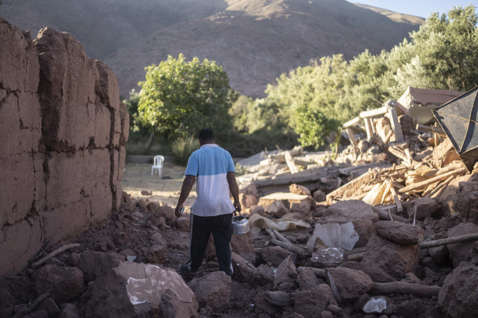 Mohammed Elhmatif walks amidst the rubble of his home which was damaged by the earthquake, in Ijjoukak village, near Marrakech, Morocco, Saturday, Sept. 9, 2023. A rare, powerful earthquake struck Morocco, sending people racing from their beds into the streets and toppling buildings in mountainous villages and ancient cities not built to withstand such force. (AP Photo/Mosa'ab Elshamy)