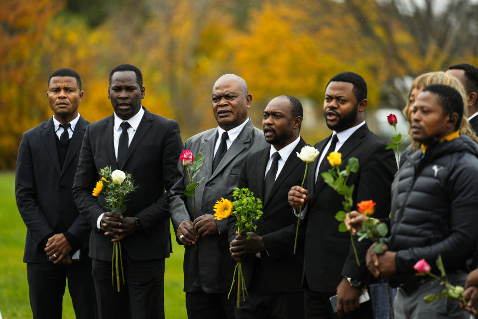 Members of the New Apostolic Church sing at a makeshift memorial outside a bowling alley, the site of one of this week's mass shootings, Sunday, Oct. 29, 2023, in Lewiston, Maine. A gunman killed multiple people at the bowling alley and a bar in Lewiston on Wednesday. (AP Photo/Matt Rourke)