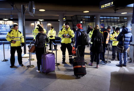 Security staff check people's identification at Kastrups train station outside Copenhagen, January 4, 2016. REUTERS/Bjorn Lindgren/TT News Agency