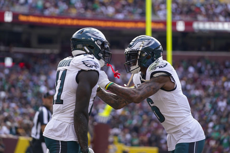 Philadelphia Eagles wide receiver A.J. Brown (11) celebrating his touchdown with teammate wide receiver DeVonta Smith (6) during the first half of an NFL football game against Washington Commanders, Sunday, Oct. 29, 2023, in Landover, Md. (AP Photo/Alex Brandon)