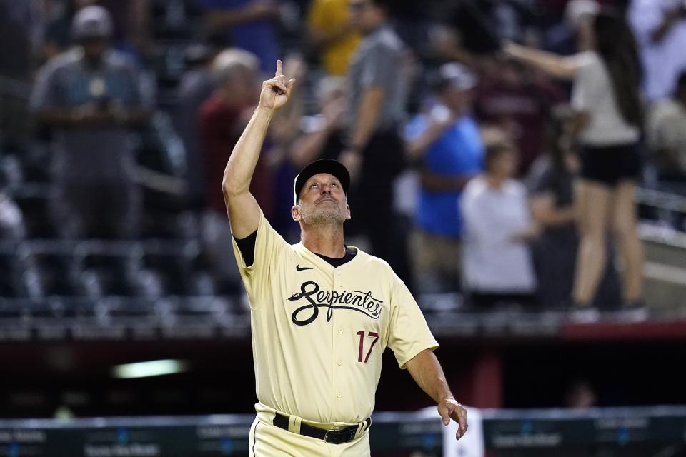 Arizona Diamondbacks manager Torey Lovullo points to the sky as he comes out of the dugout after the final out of the team's baseball game against the Colorado Rockies on Friday, Aug. 5, 2022, in Phoenix. The Diamondbacks won 6-5. (AP Photo/Ross D. Franklin)