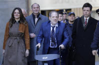 Harvey Weinstein, center, leaves a Manhattan courthouse after closing arguments in his rape trial in New York, Friday, Feb. 14, 2020. (AP Photo/Seth Wenig)