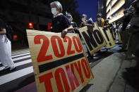 People who are against the Tokyo 2020 Olympics set to open in July, march around Tokyo's National Stadium during an anti-Olympics demonstration Sunday, May 9, 2021, (AP Photo/Eugene Hoshiko)