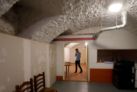 Andras Fekete-Gyor, leader of political movement Momentum which challenges Budapest's 2024 Olympic bid with a referendum, speaks on his phone at Momentum's headquarters located in a basement in Budapest, Hungary, February 20, 2017. REUTERS/Laszlo Balogh