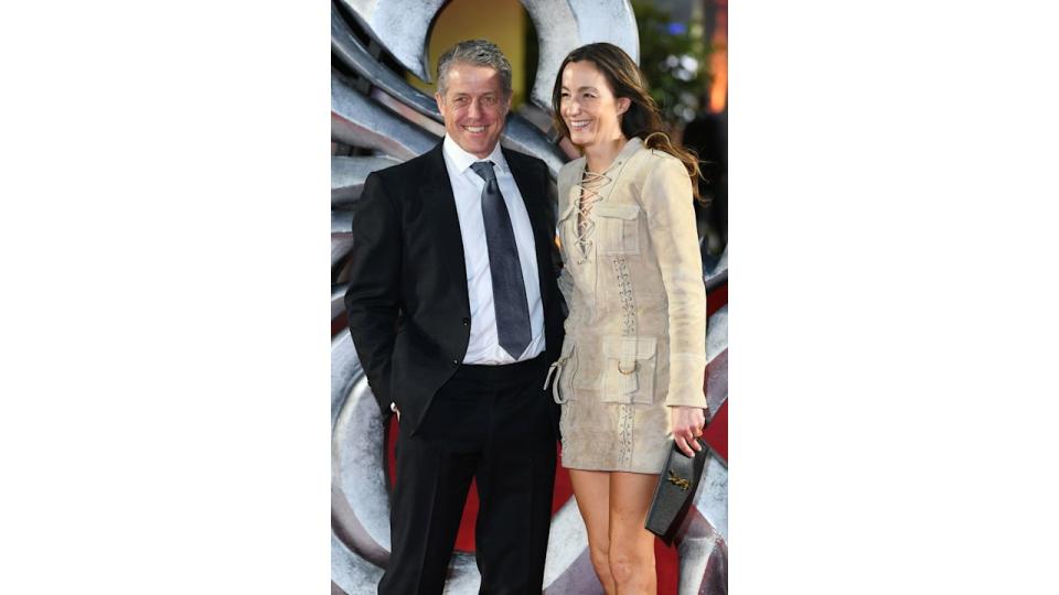 man in smart suit and woman in beige dress 