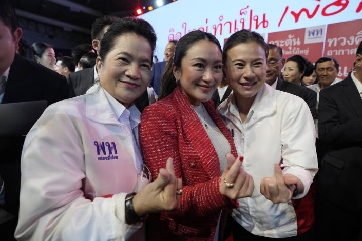 Paetongtarn Shinawatra, center, one of the opposition Pheu Thai party's top politicians it is set to nominate to become the next prime minister, pose for photographer with supporters at Thammasat University's indoor gymnasium in Pathum Thani province, north of Bangkok, Thailand, on Friday, March 17, 2023. Thailand’s largest opposition party unveiled on Friday a list of policies and 400 prospective candidates they will be fielding in the upcoming elections expected to take place in May. Paetongtarn Shinawatra is daughter of former prime minister Thaksin Shinawatra. (AP Photo/Sakchai Lalit)