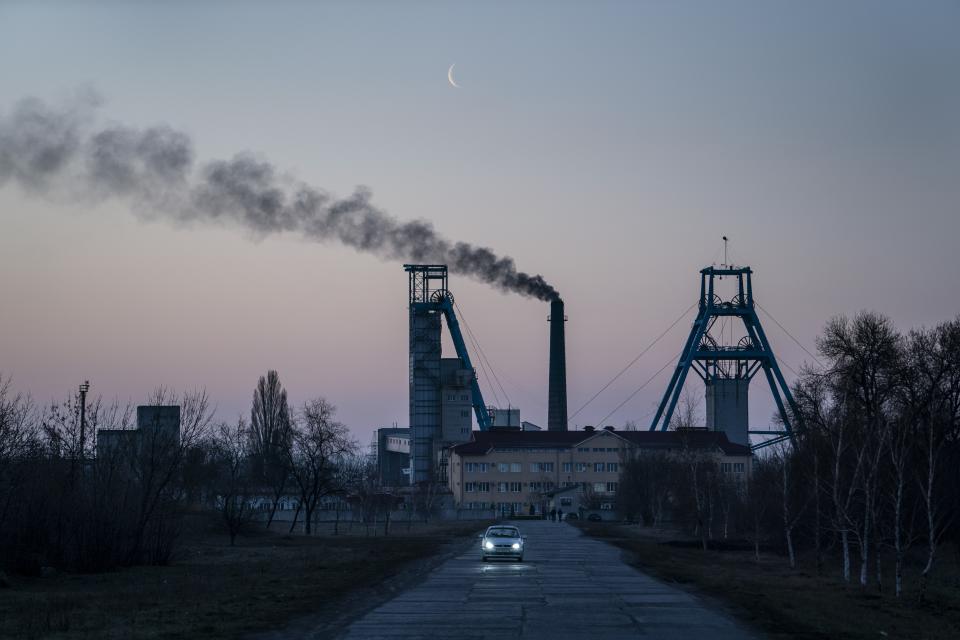 FILE - In this Monday, April 1, 2019 file photo, the Stepova coal mine just before dawn in Pershotravensk, Dnipropetrovsk region, eastern Ukraine. Volodymyr Zelenskiy, who takes the presidential oath on Monday May 20, 2019, comes into the post having never held political office; his popularity is rooted in playing the role of president on a television sit-com. (AP Photo/Evgeniy Maloletka, File)