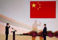 Hong Kong Chief Executive Leung Chun-ying (L) takes oath in front of Chinese President Hu Jintao during the inauguration of the new government in Hong Kong, July 1, 2012. When he took office in 2012, Chief Executive Leung Chun-ying pledged to make housing more affordable and to bring greater democracy to Hong Kong, issues that had stymied his predecessors. As he prepares to leave office, home prices continue to rise despite repeated cooling measures and political reforms have stalled. REUTERS/Bobby Yip/File photo