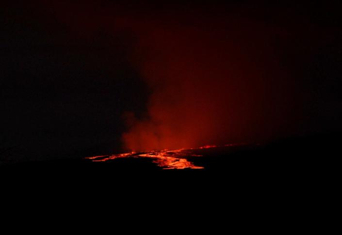 Walls of lava as tall as 200 ft were seen flowing from Mauna Loa, the US Geological Survey said Monday night, though most of the fountains remained only a few yards tall ((Chelsea Jensen/West Hawaii Today via AP))