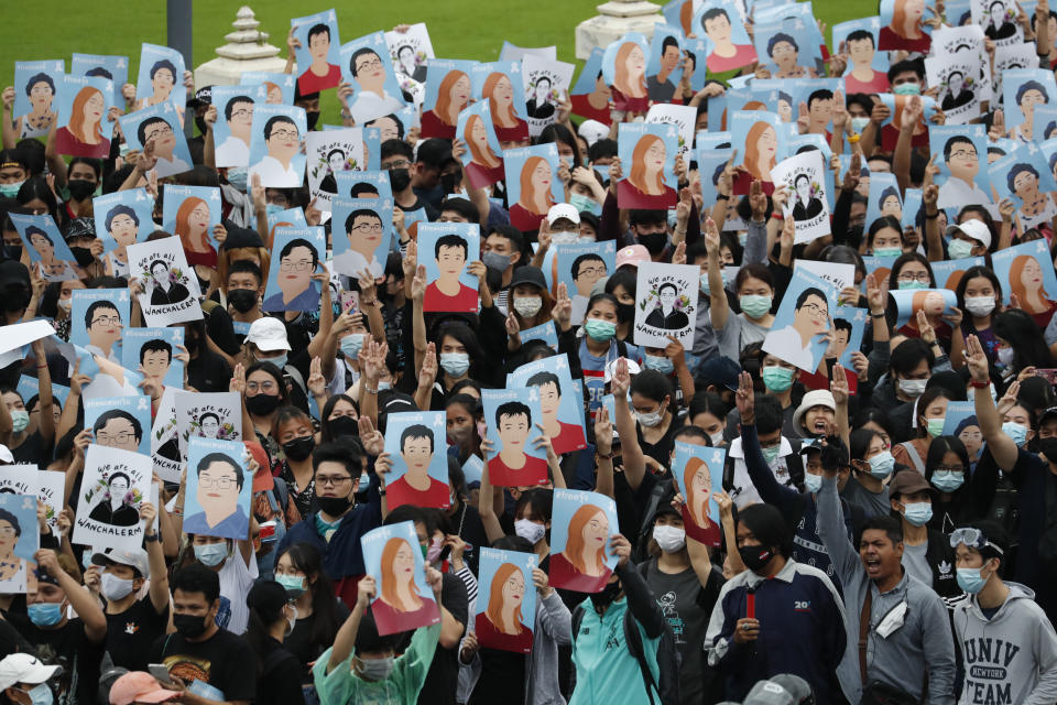 Pro-democracy demonstrators hold posters of protest leaders who have been arrested, during an anti-government protest at Victory Monument in Bangkok, Thailand, Sunday, Oct. 18, 2020. Pro-democracy activists in Thailand launched their fifth straight days of protests on Sunday, scheduling demonstrations not just in the capital but also at several other locations around the country. (AP Photo/Sakchai Lalit)