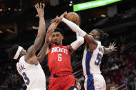 Houston Rockets' Kenyon Martin Jr. (6) is fouled by Washington Wizards' Delon Wright (55) as Bradley Beal (3) helps defend during the first half of an NBA basketball game Wednesday, Jan. 25, 2023, in Houston. (AP Photo/David J. Phillip)