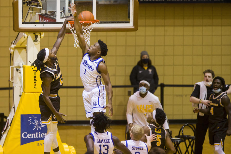 Valparaiso's Sheldon Edwards, left, dunks against Drake's Joseph Yesufu (1) during the second half of an NCAA college basketball game on Sunday, Feb. 7, 2021, in Valparaiso, Ind. (AP Photo/Robert Franklin)