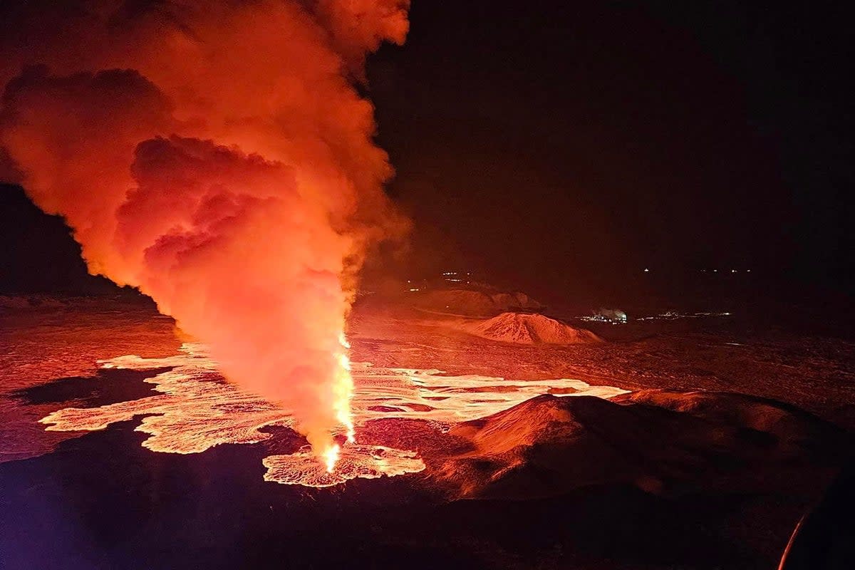 Billowing smoke and flowing lava are seen pouring out of a new fissure in this Icelandic Department of Civil Protection and Emergency Management , 8 February 2024 (AFP via Getty Images)