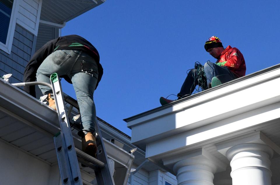 The team from Delmarva Christmas Lights decorates The Lodge at Historic Lewes in Lewes, Delaware.