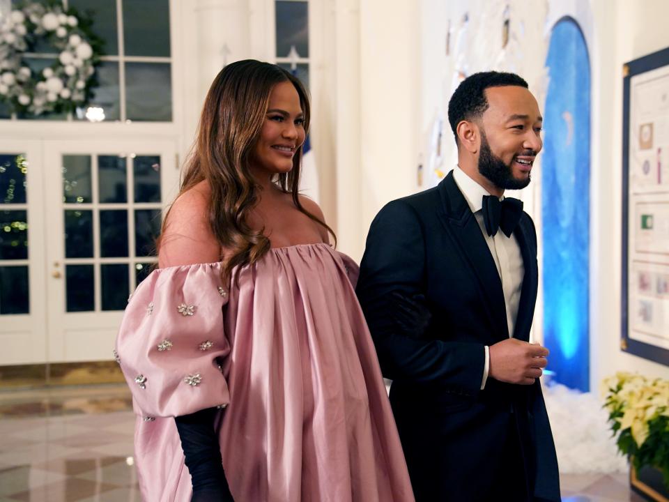 John Legend and Chrissy Teigen arrive for the White House state dinner for French President Emmanuel Macron at the White House on December 1, 2022 in Washington, DC.