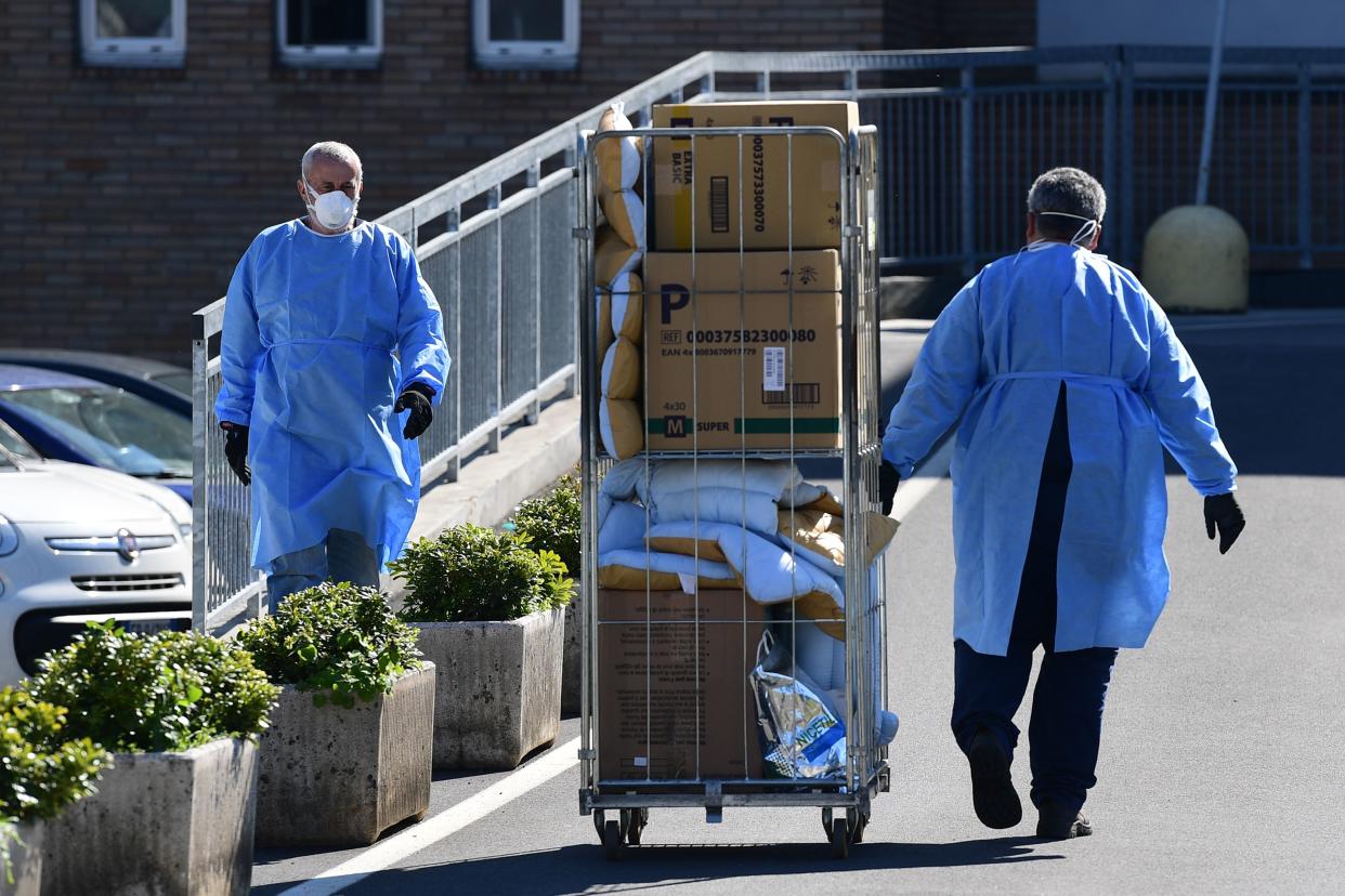 A worker pushes a cart at the hospital in Codogno, southeast of Milan, on March 11, 2020 a day after Italy imposed unprecedented national restrictions on its 60 million people Tuesday to control the deadly COVID-19 coronavirus. (Photo by Miguel MEDINA / AFP) (Photo by MIGUEL MEDINA/AFP via Getty Images)