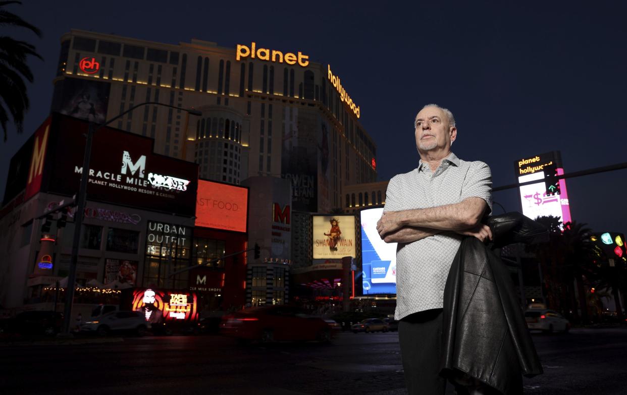 Jeff German, host of "Mobbed Up," poses with Planet Hollywood, formerly the Aladdin, in the background on the Strip in Las Vegas, Wednesday, June 2, 2021.