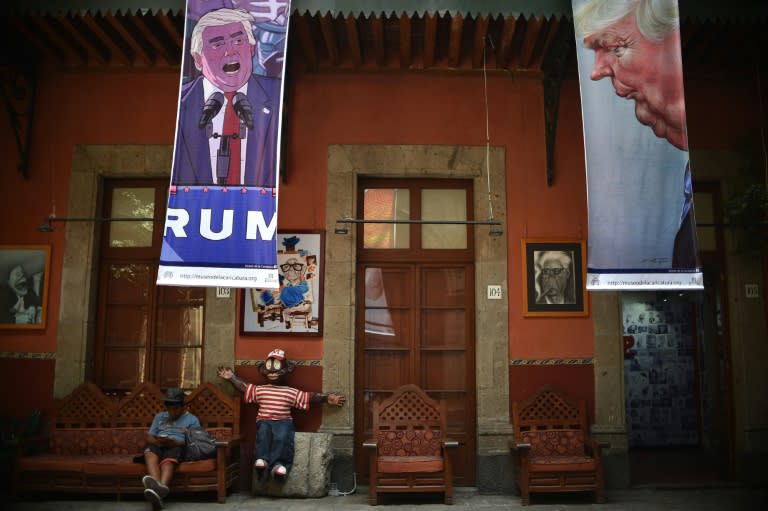 Banners depicting US Republican presidential candidate Donald Trump hang as part of "A Wall of Caricatures" exhibition, at the Caricature Museum in Mexico City on October 17, 2016