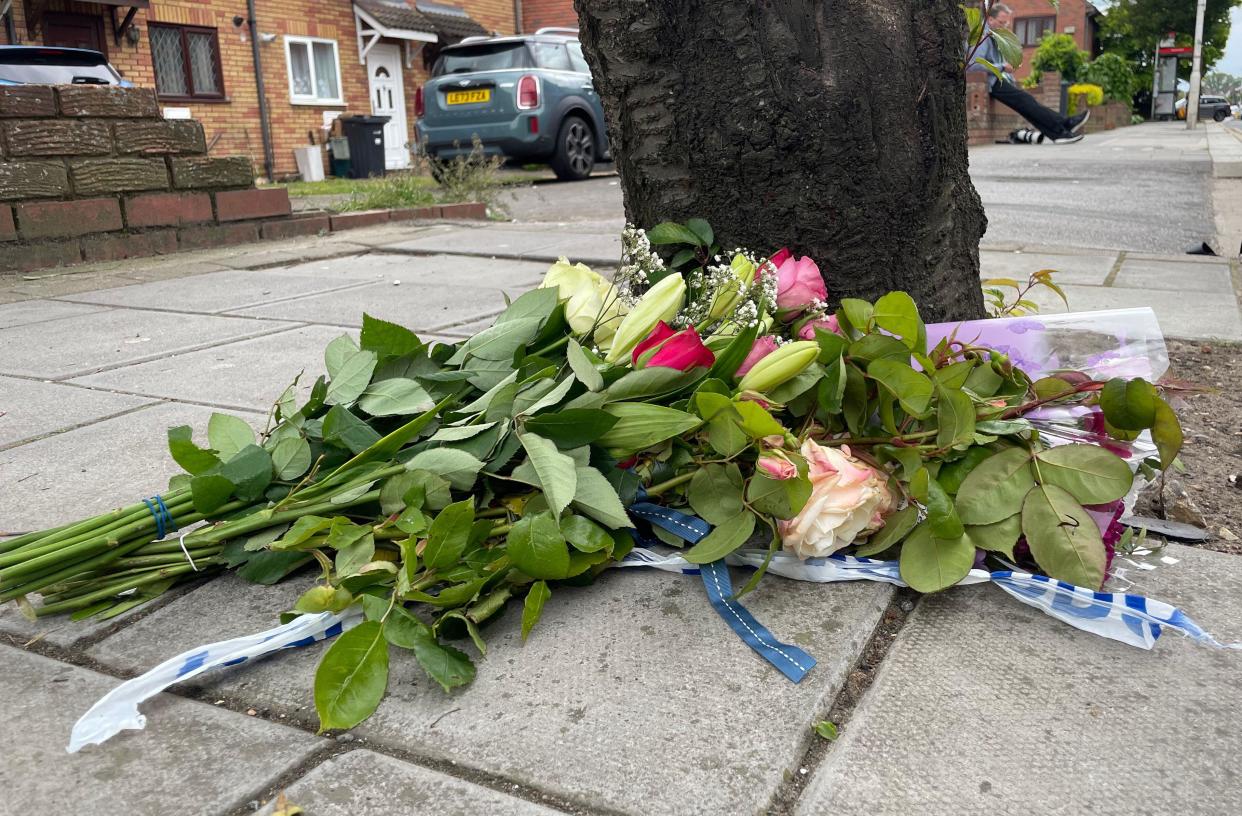 Floral tributes left near the police cordon in Hainault, north east London, where a 14-year-old boy was killed in a sword attack on Tuesday, that saw four others injured, including two Metropolitan Police officers. A 36-year-old man was tasered and arrested, then taken to hospital, after sustaining injuries when his van hit a house. Picture date: Wednesday May 1, 2024.