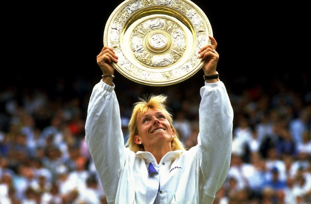 martina navratilova of the usa holds up the winners'' plate